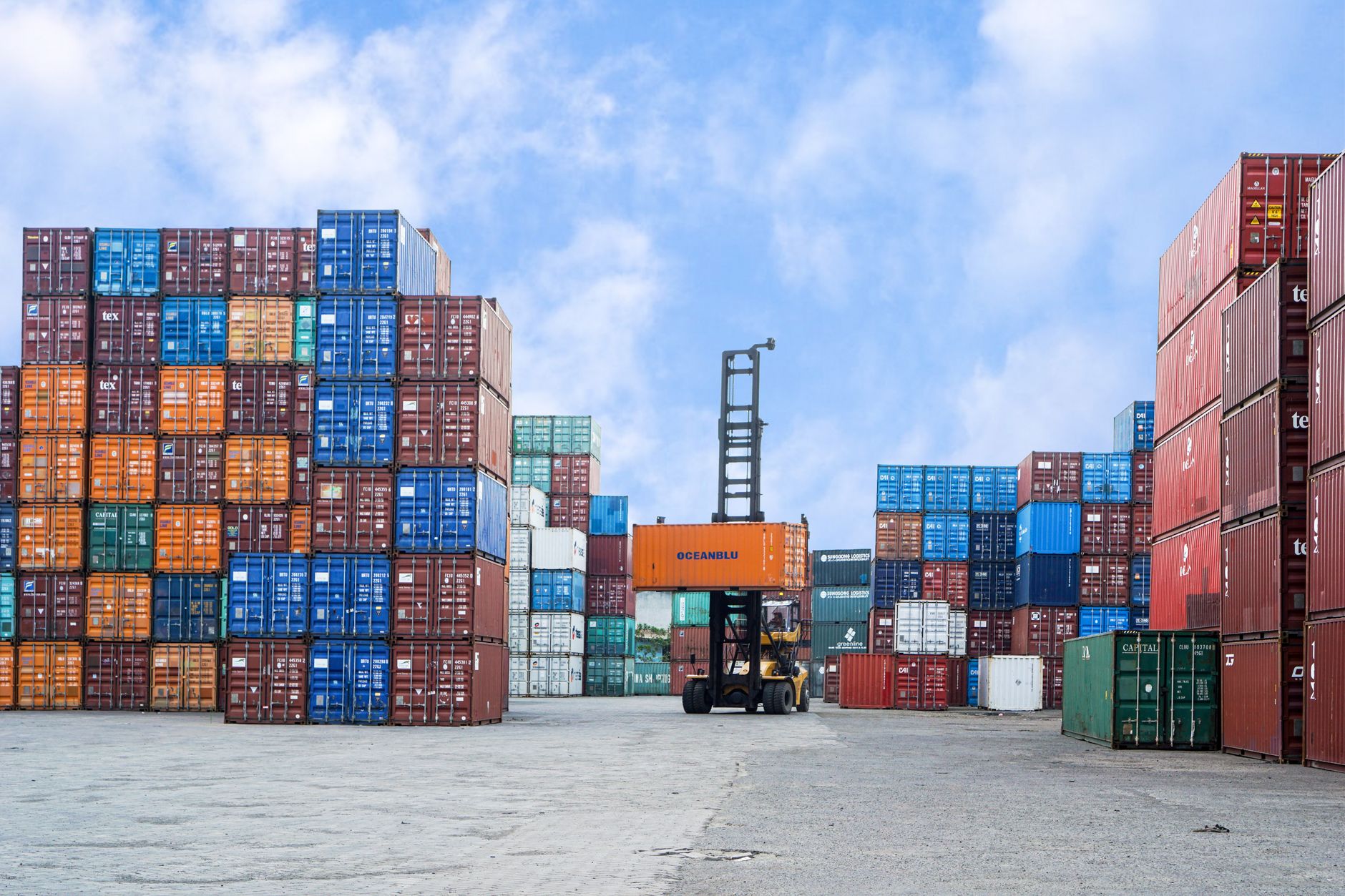 Stacked intermodal shipping containers at a rail yard, illustrating freight logistics and transport capacity
