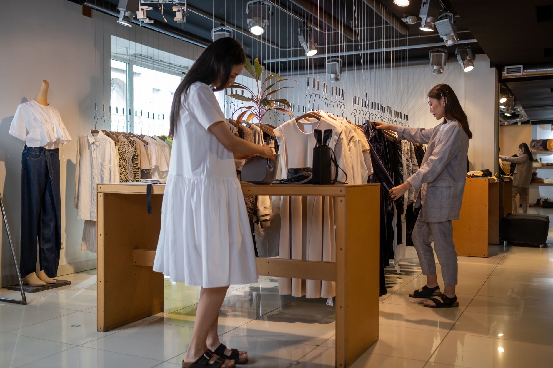 Quiet retail store interior with staff visible and minimal customer activity