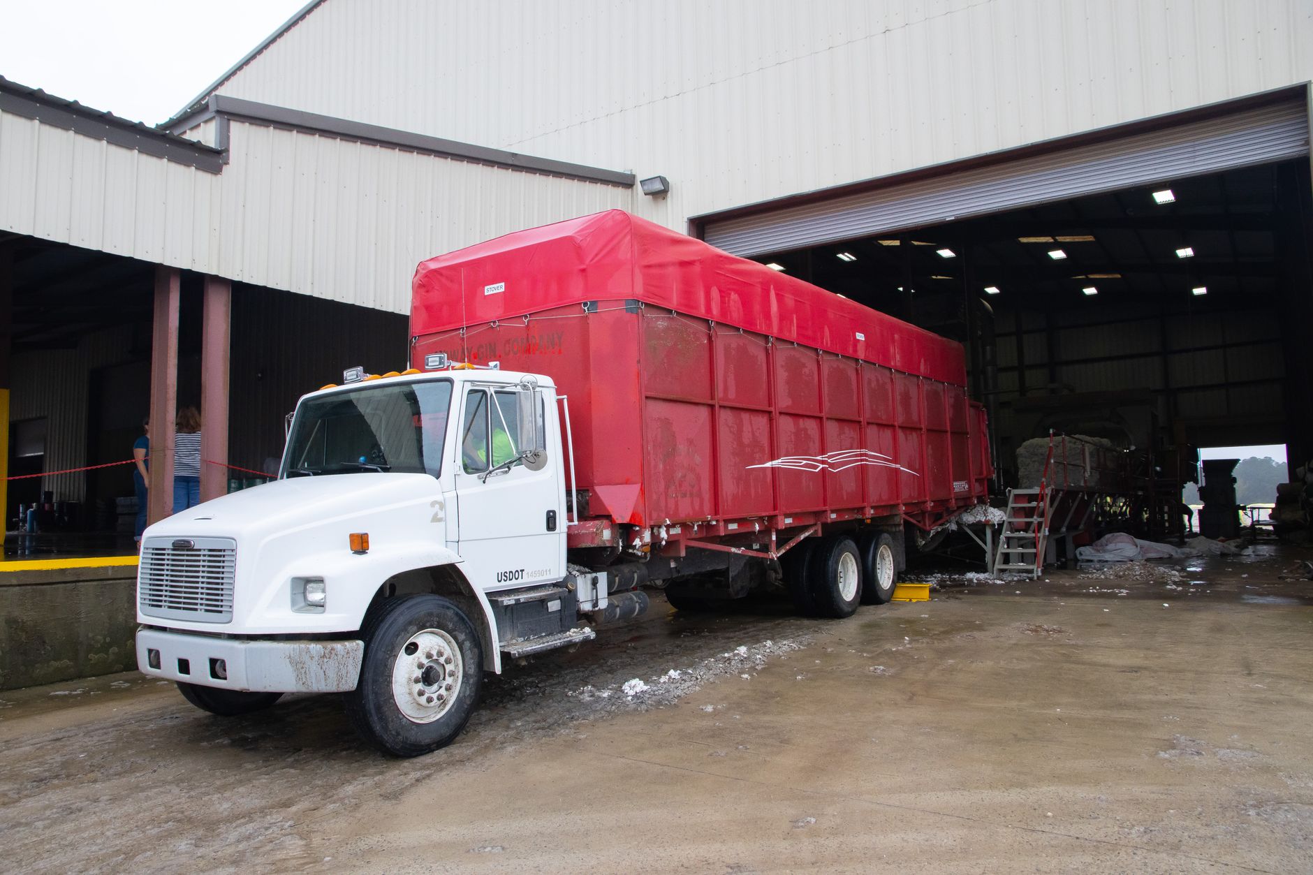 Trucks parked outside a large logistics and warehouse distribution facility