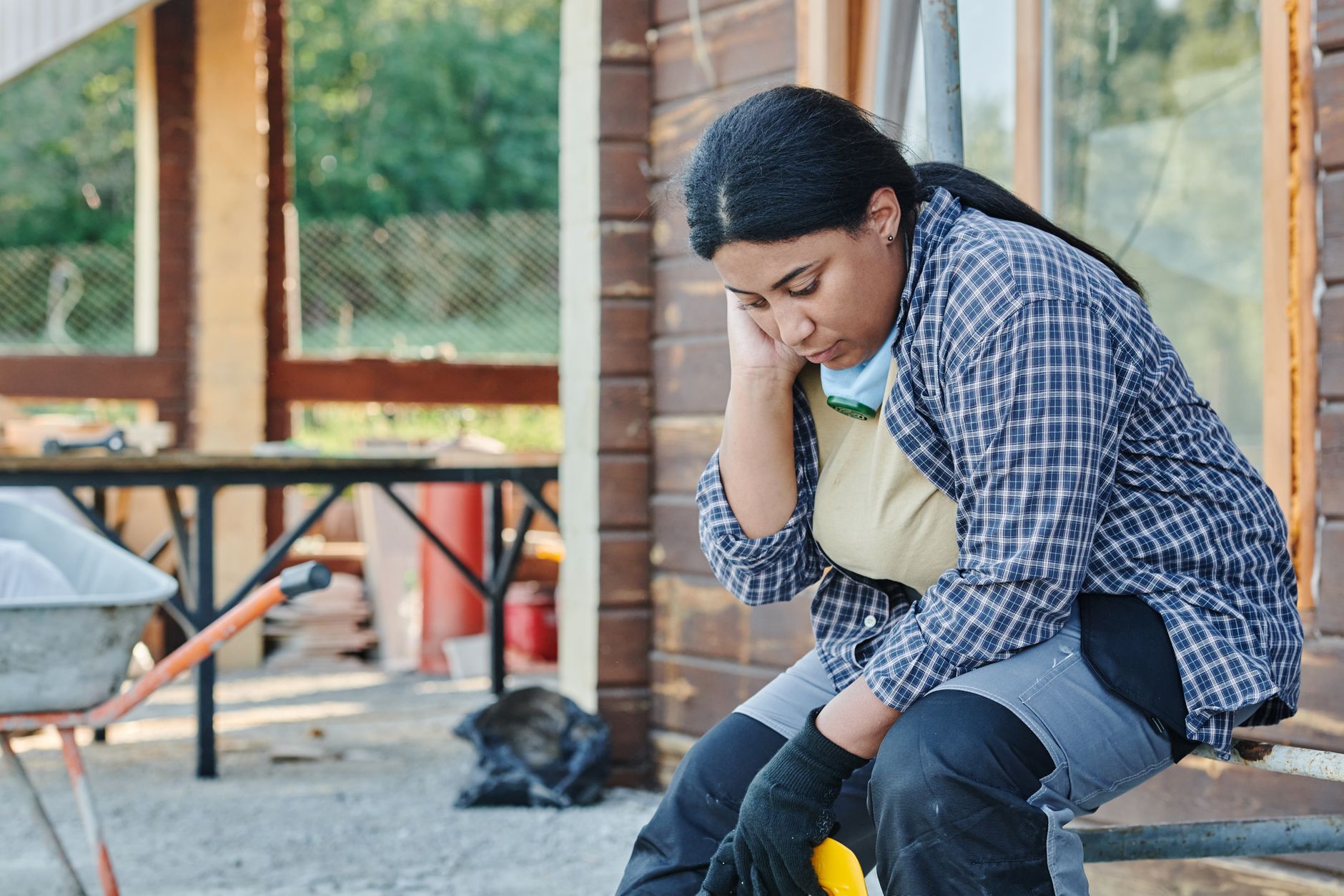 Solar installation worker on a rooftop reviewing project plans