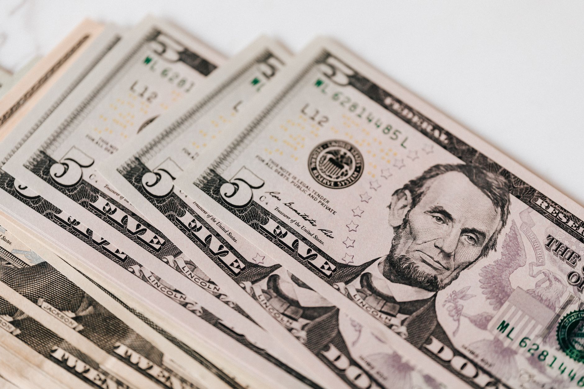 Stack of cash and financial paperwork representing deferred business investment