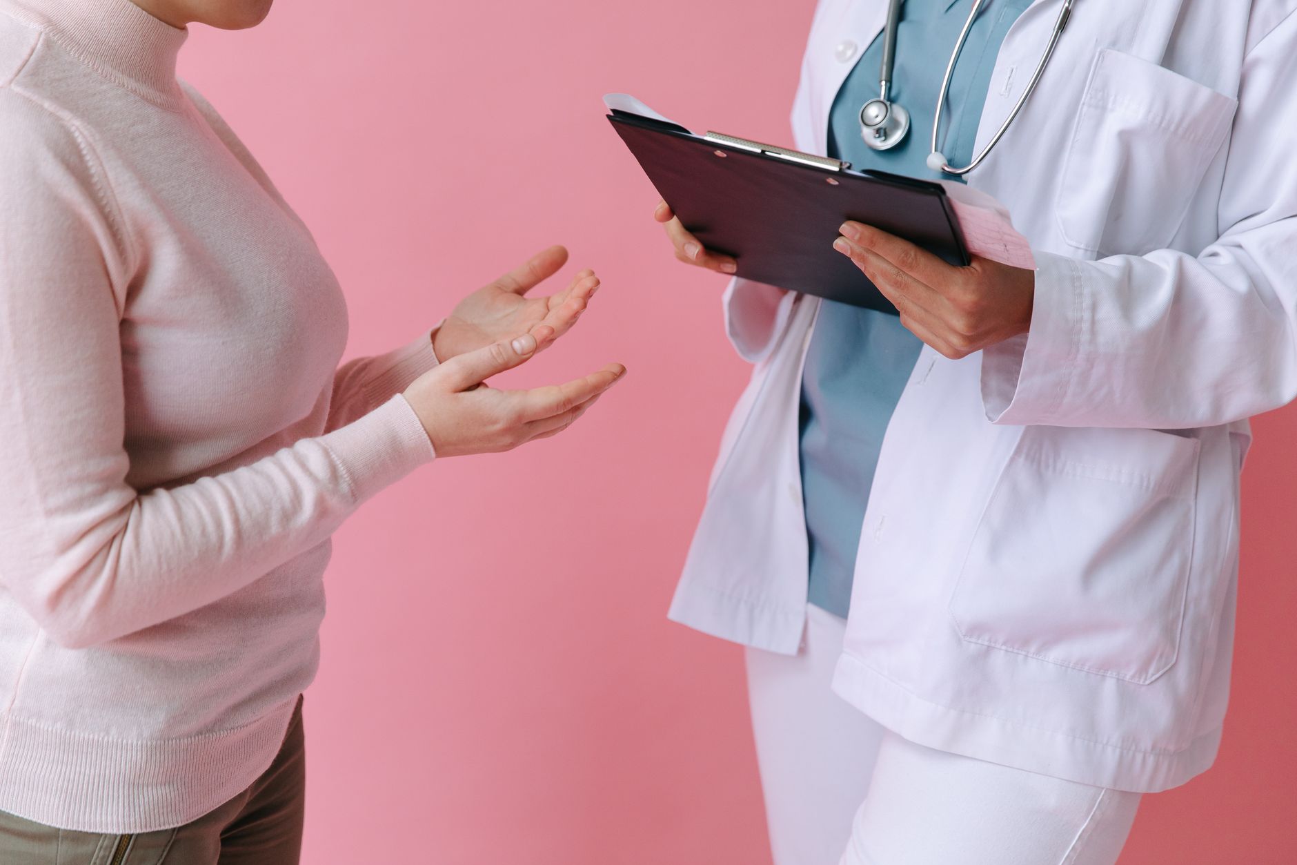 Doctor speaking with a patient in a clinical setting representing Medicaid care access concerns