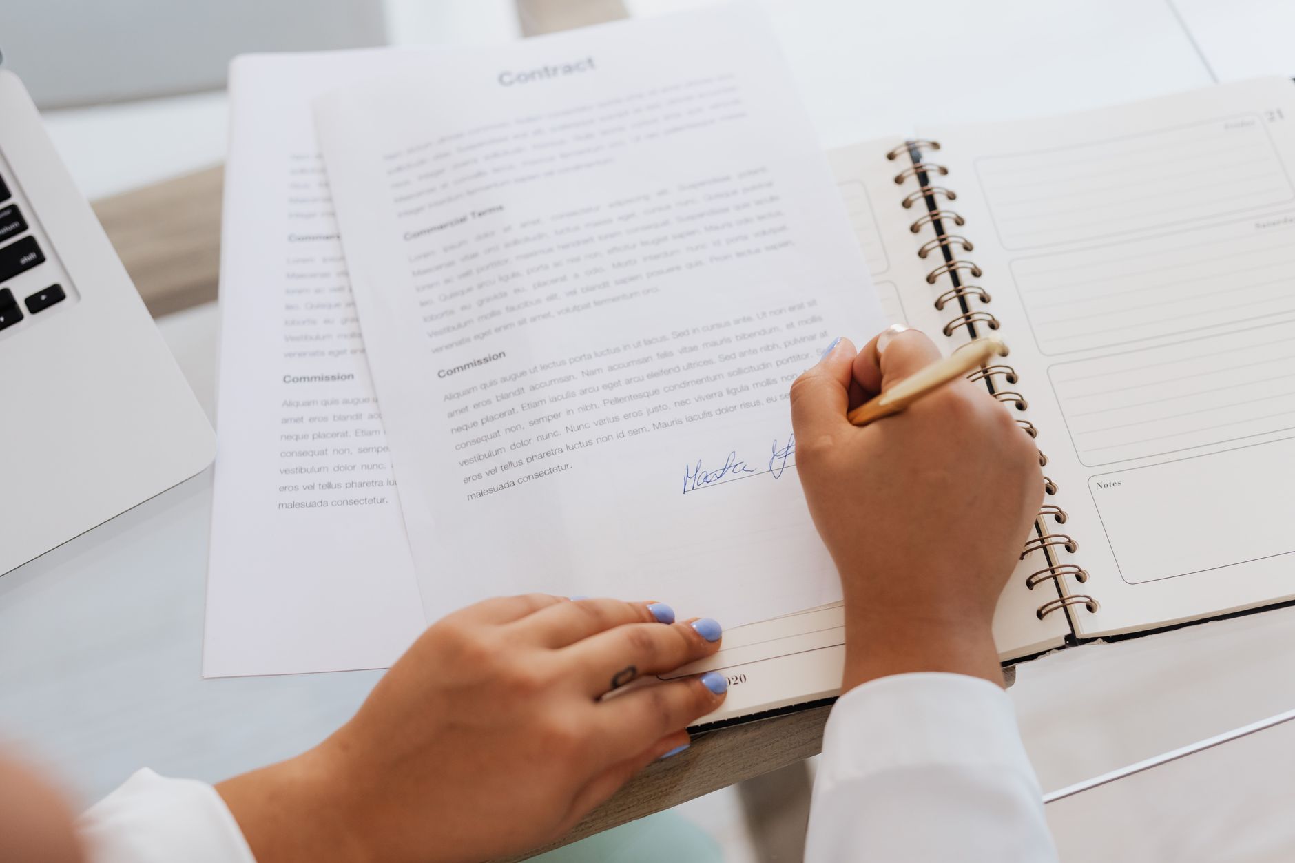 Two professionals reviewing and signing a direct shipping contract agreement