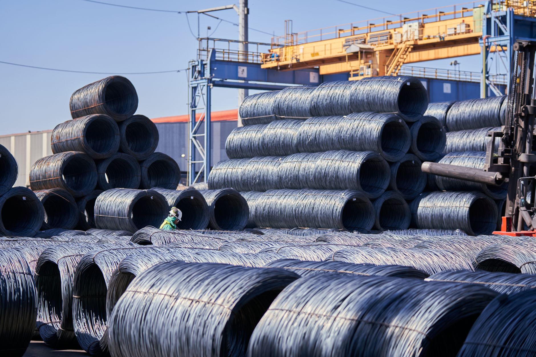 Steel coils moving through a rolling mill production line