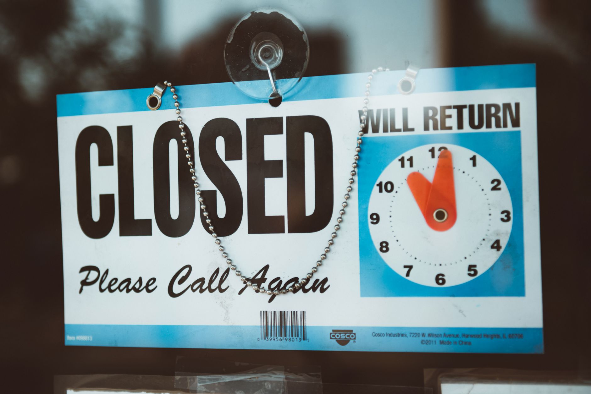 Closed sign on the door of a small business representing a shuttered childcare center