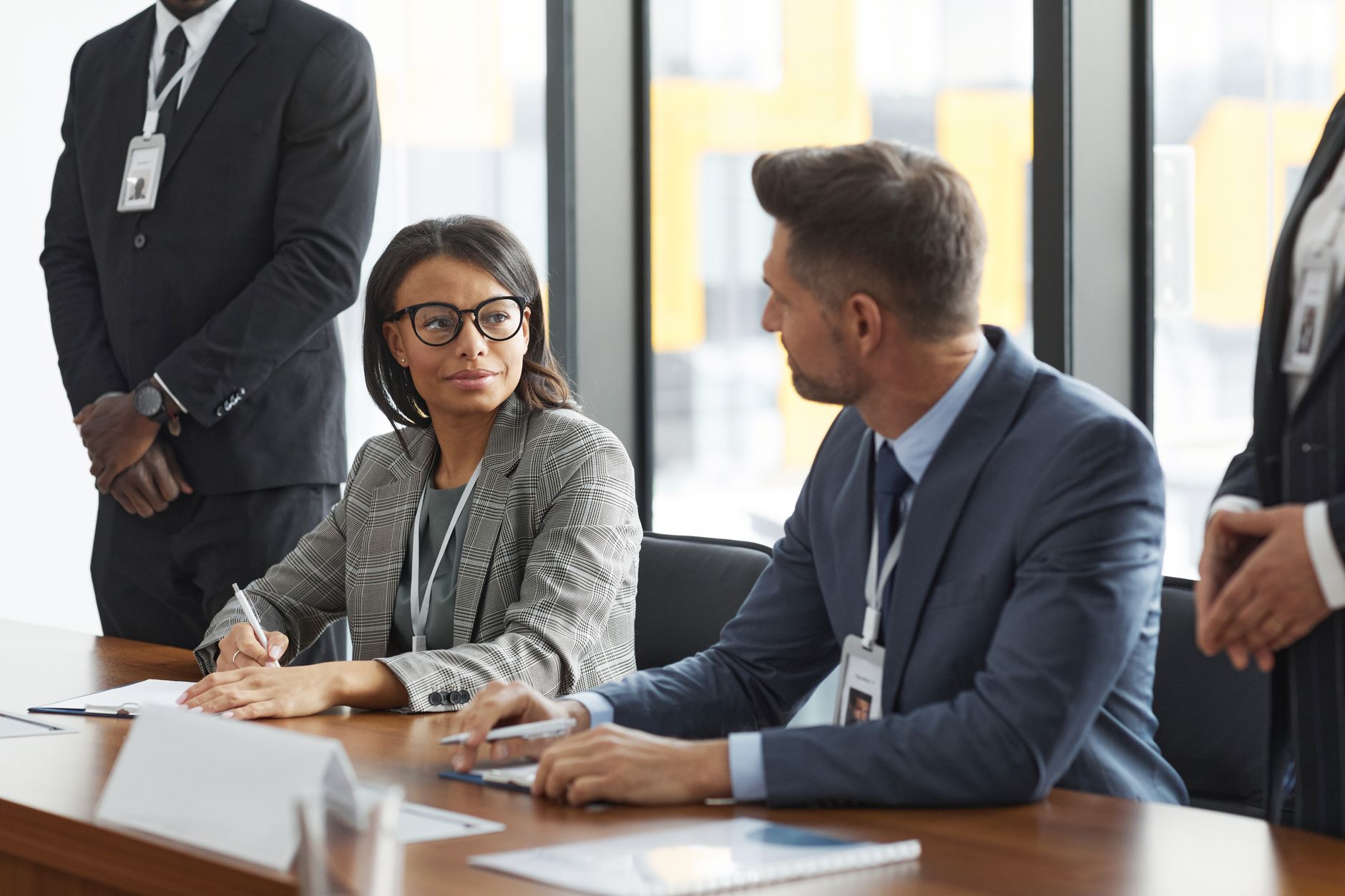 Corporate executives in a boardroom discussion reviewing financial reports