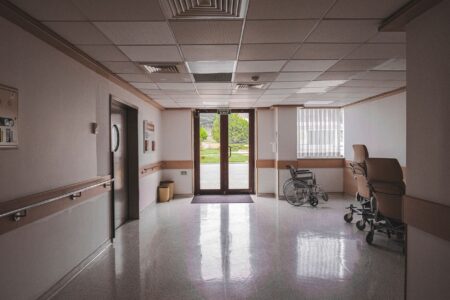 Empty hospital corridor representing healthcare staffing and Medicaid billing challenges