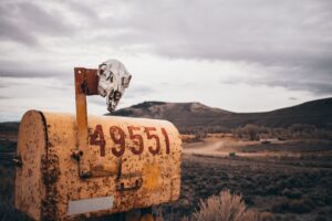 A rural mailbox on a remote country road, representing mail delivery in isolated communities
