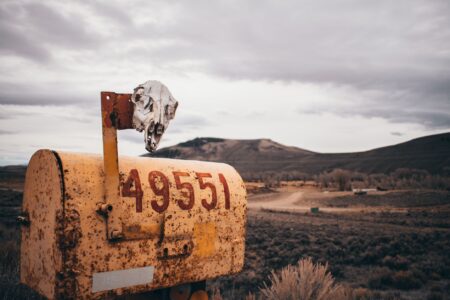 A rural mailbox on a remote country road, representing mail delivery in isolated communities
