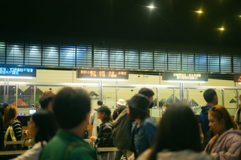 A long line of people waiting outside a government building for rental assistance