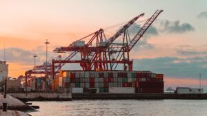 Large shipping cranes at a busy container port terminal