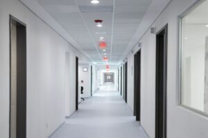 Empty hallway inside a medical treatment clinic representing healthcare access challenges