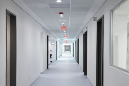 Empty hallway inside a medical treatment clinic representing healthcare access challenges