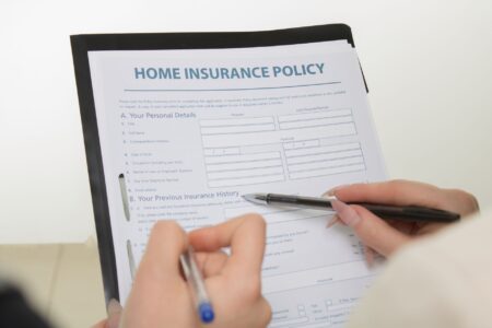 Medicaid Managed Care Rate Freezes Quietly Pressure Safety-Net Insurers Office workers reviewing insurance contracts and financial documents at a desk
