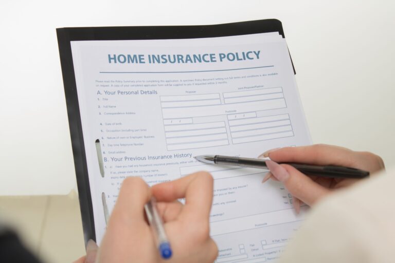 Medicaid Managed Care Rate Freezes Quietly Pressure Safety-Net Insurers Office workers reviewing insurance contracts and financial documents at a desk