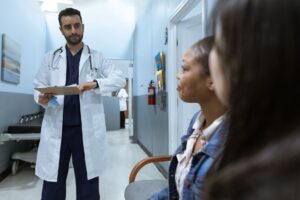 Medicaid Redetermination Backlogs Quietly Overwhelm State DSH Payments Hospital billing desk with paperwork and computer screens showing patient records