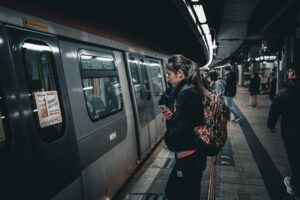 Transit Agency Fare Hike Plans Collide With Falling Ridership Budgets Commuters walking through a busy urban subway station during rush hour