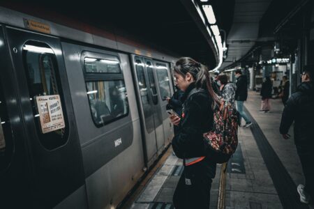 Transit Agency Fare Hike Plans Collide With Falling Ridership Budgets Commuters walking through a busy urban subway station during rush hour