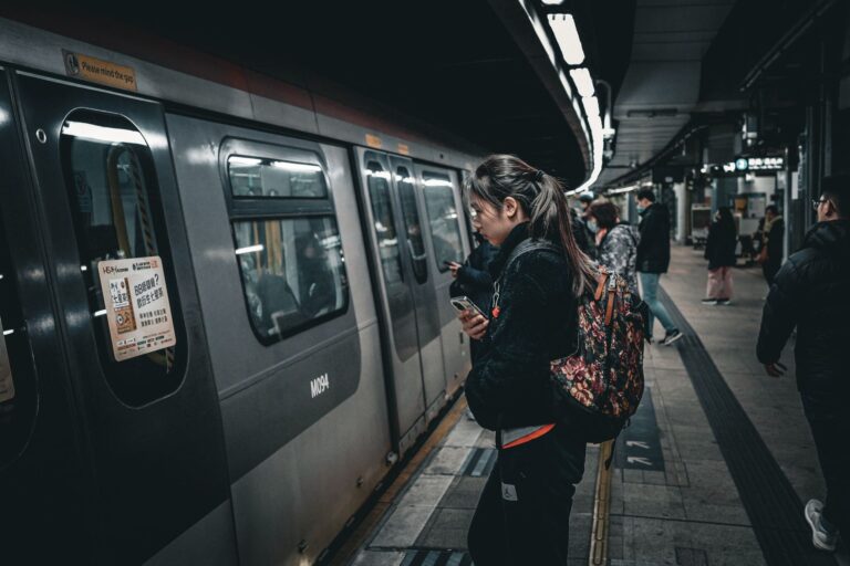 Transit Agency Fare Hike Plans Collide With Falling Ridership Budgets Commuters walking through a busy urban subway station during rush hour