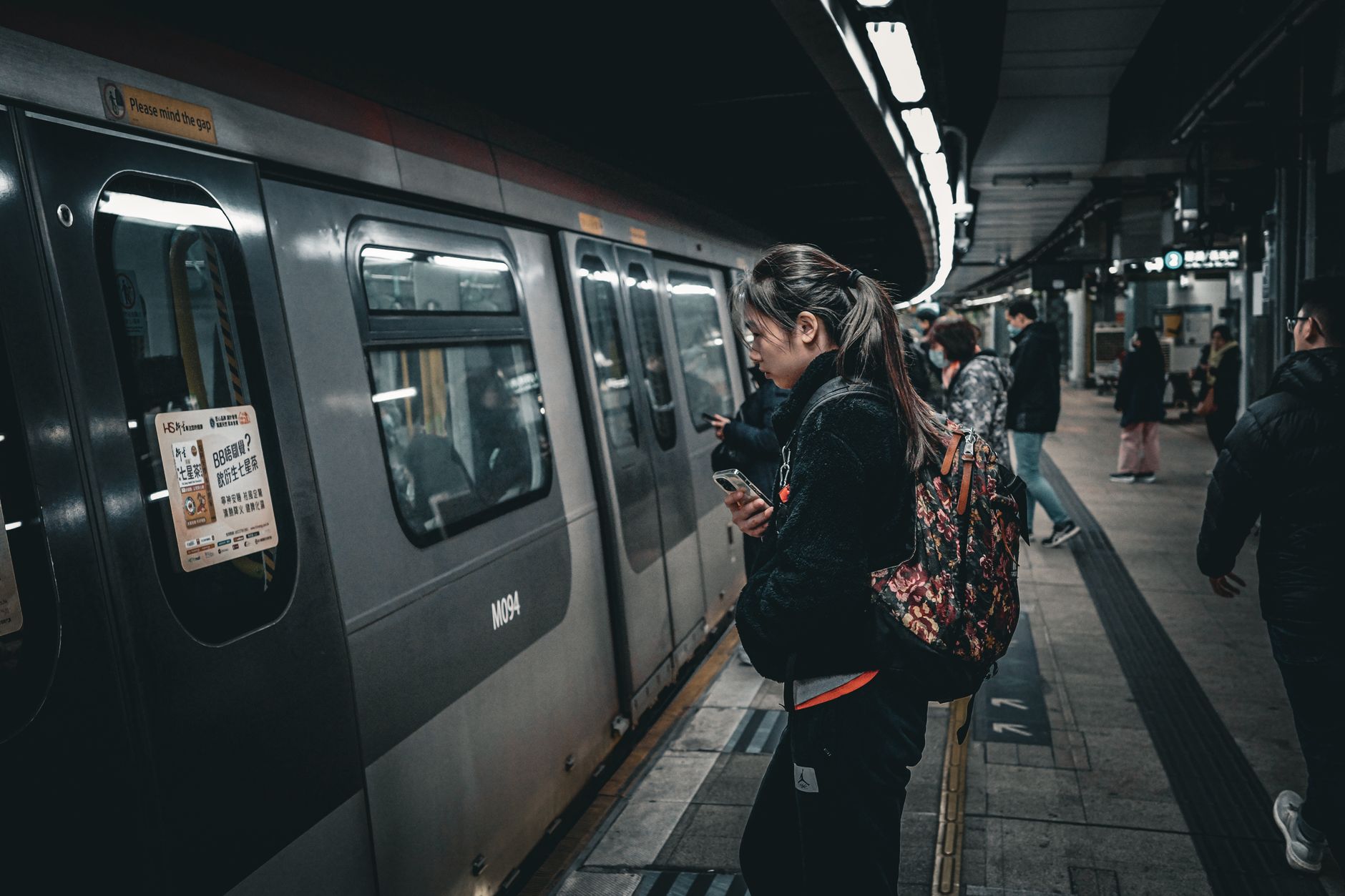 Commuters walking through a busy urban subway station during rush hour