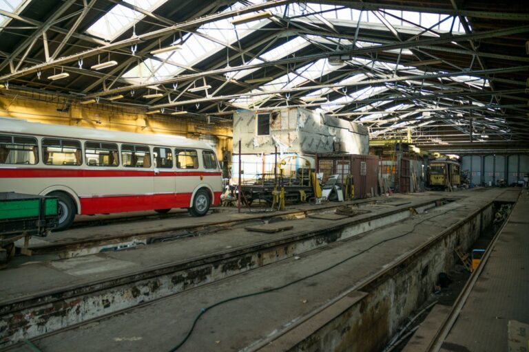 Row of public transit buses parked at a city depot facility
