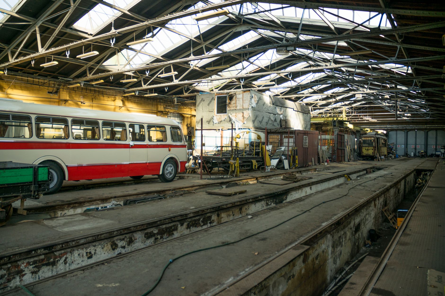 Row of public transit buses parked at a city depot facility