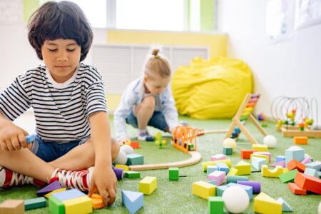 Empty childcare classroom with small chairs and tables representing center closures