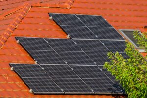 Residential solar panels installed on a suburban rooftop under clear sky