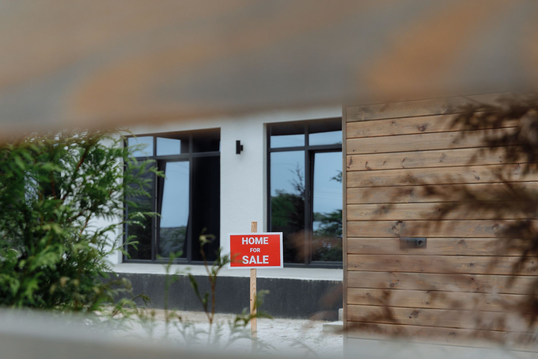 For sale sign in front of a coastal home during property listing
