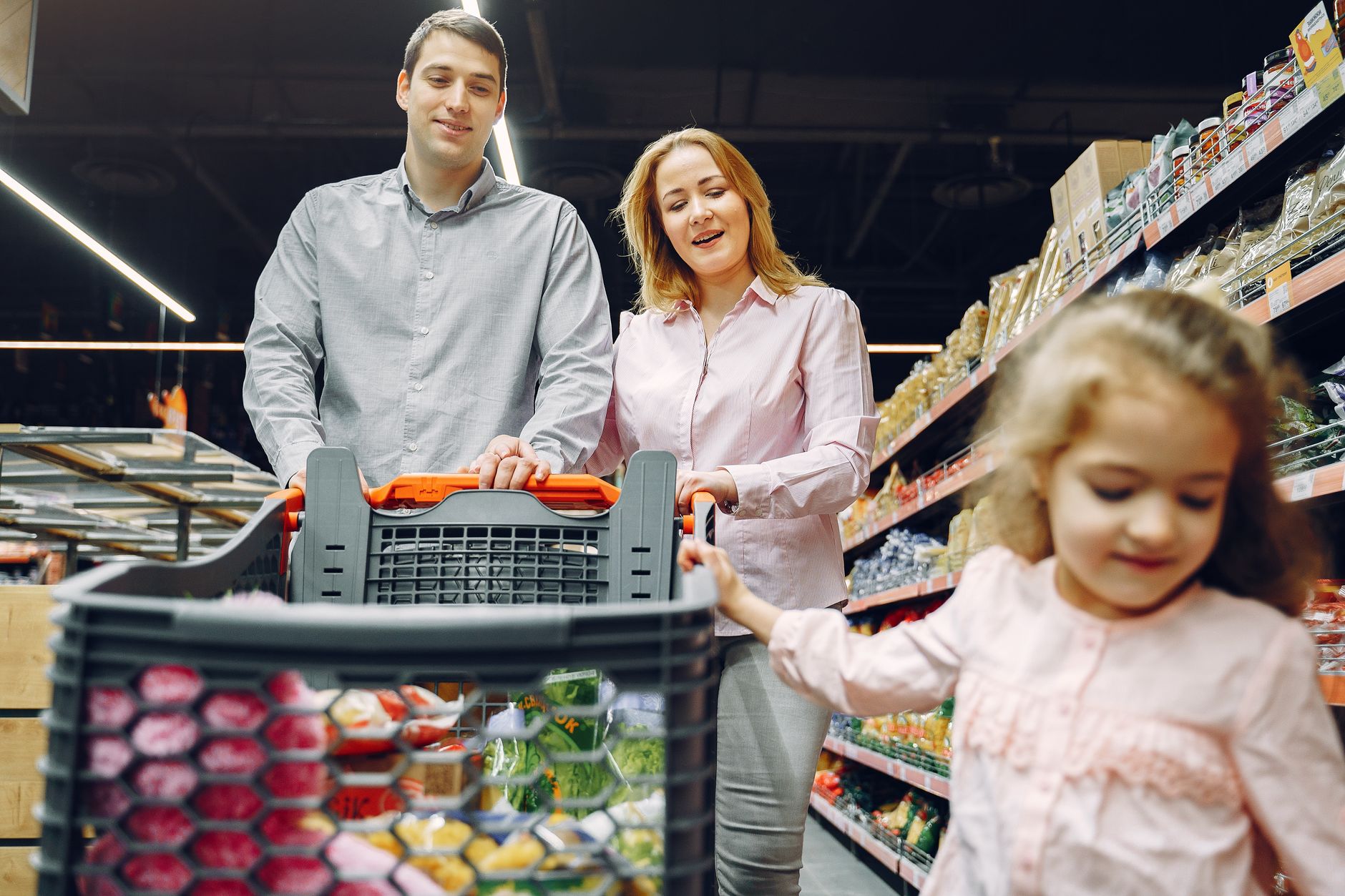 Parent and child shopping for groceries, illustrating households affected by SNAP benefit changes
