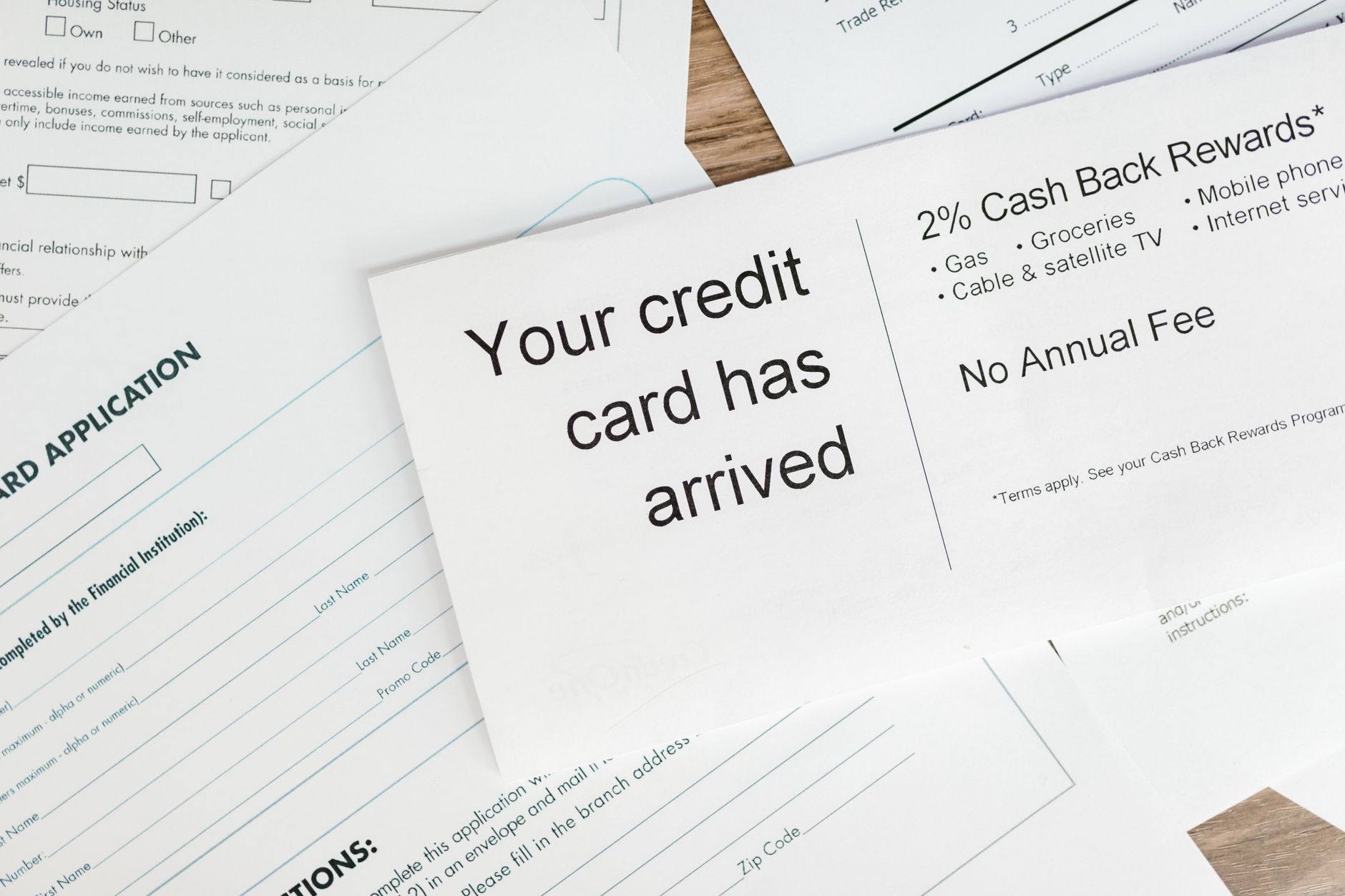 Small business owner reviewing loan documents and financial paperwork at a desk