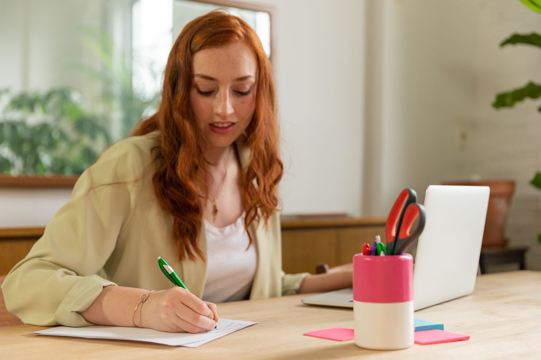 Woman working at a desk, representing mothers balancing professional responsibilities amid limited childcare access