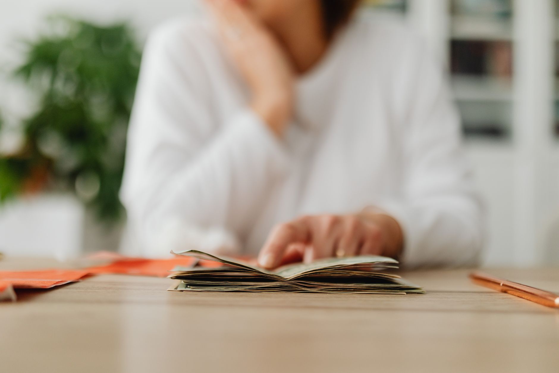 Woman reviewing finances at a table, representing low-income filers managing delayed tax refunds