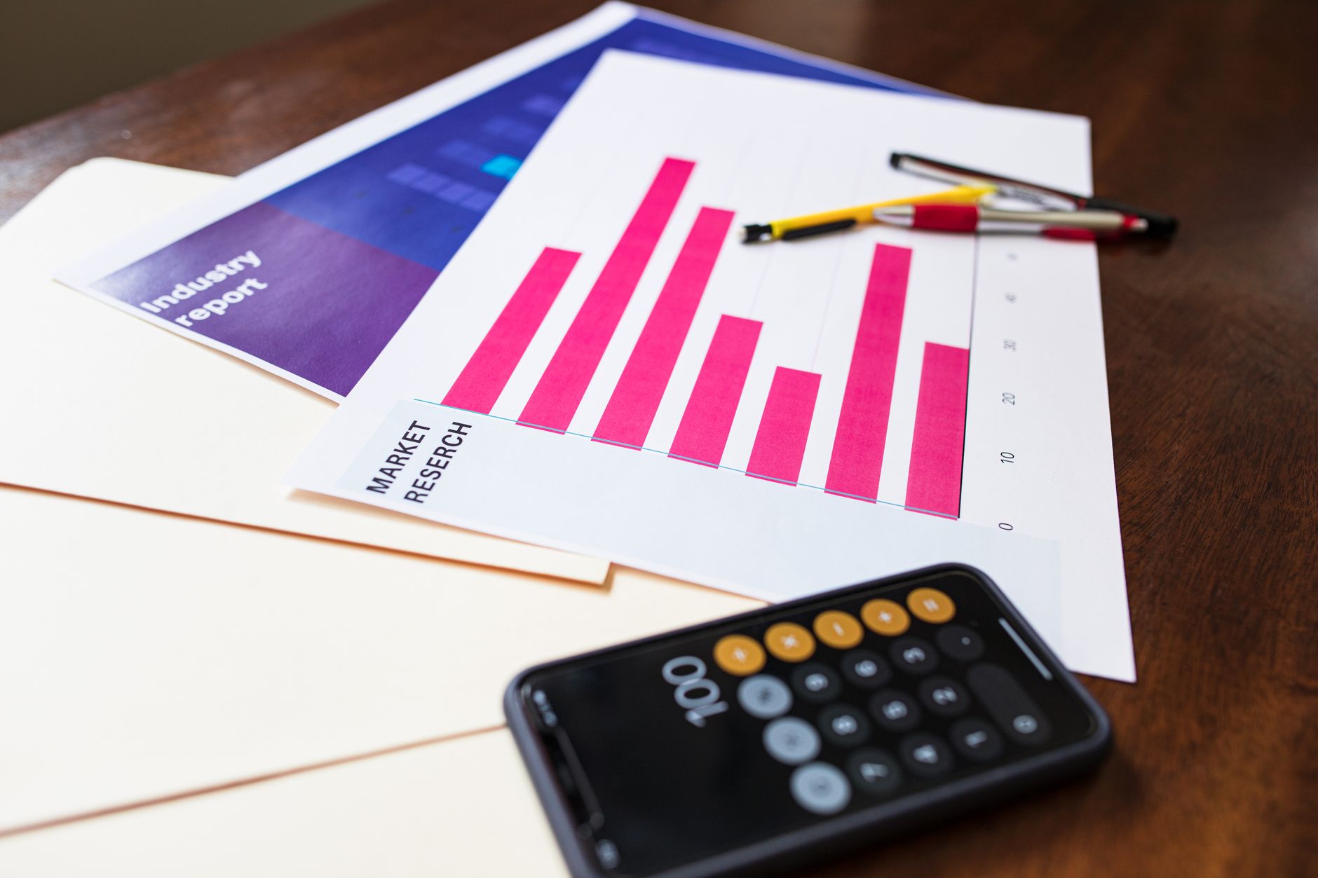 Financial analyst reviewing bond rating charts and municipal budget documents at a desk