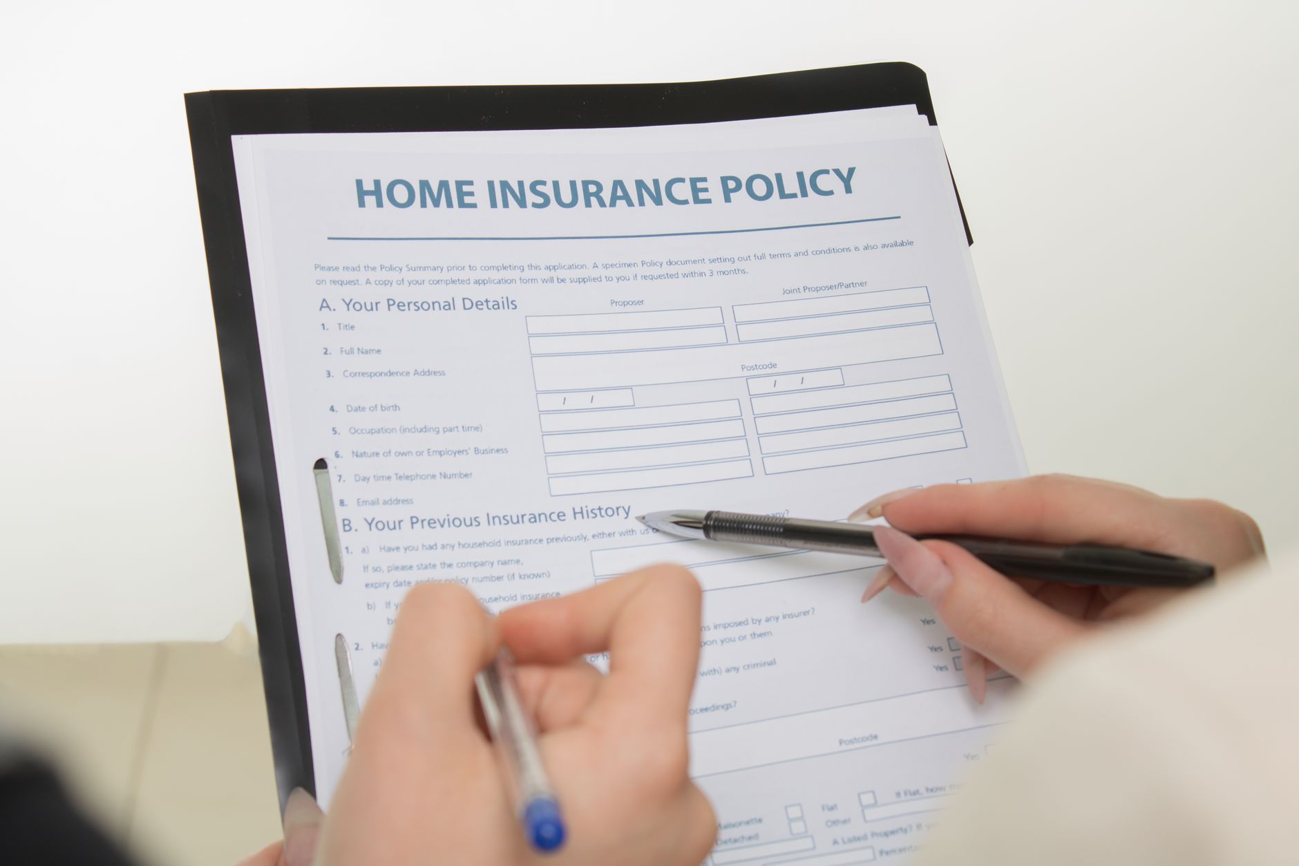 Person reviewing insurance documents at a desk