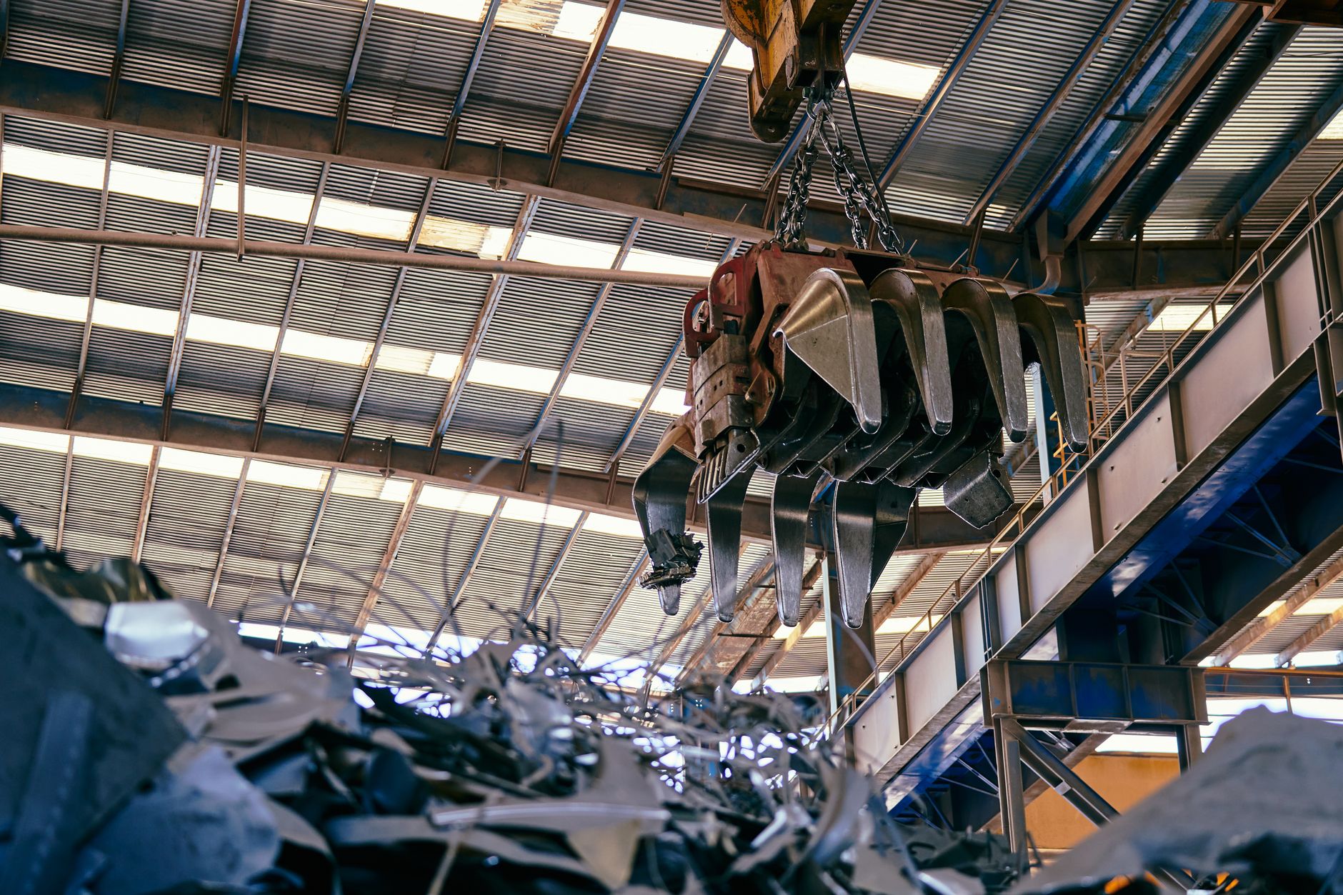 Aerial view of a scrap metal recycling yard with piles of metal materials
