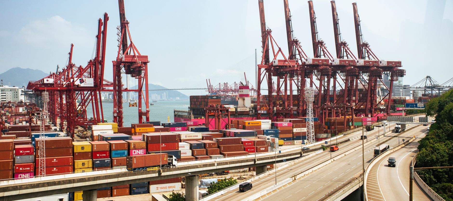 Rows of shipping containers stacked at a commercial port facility