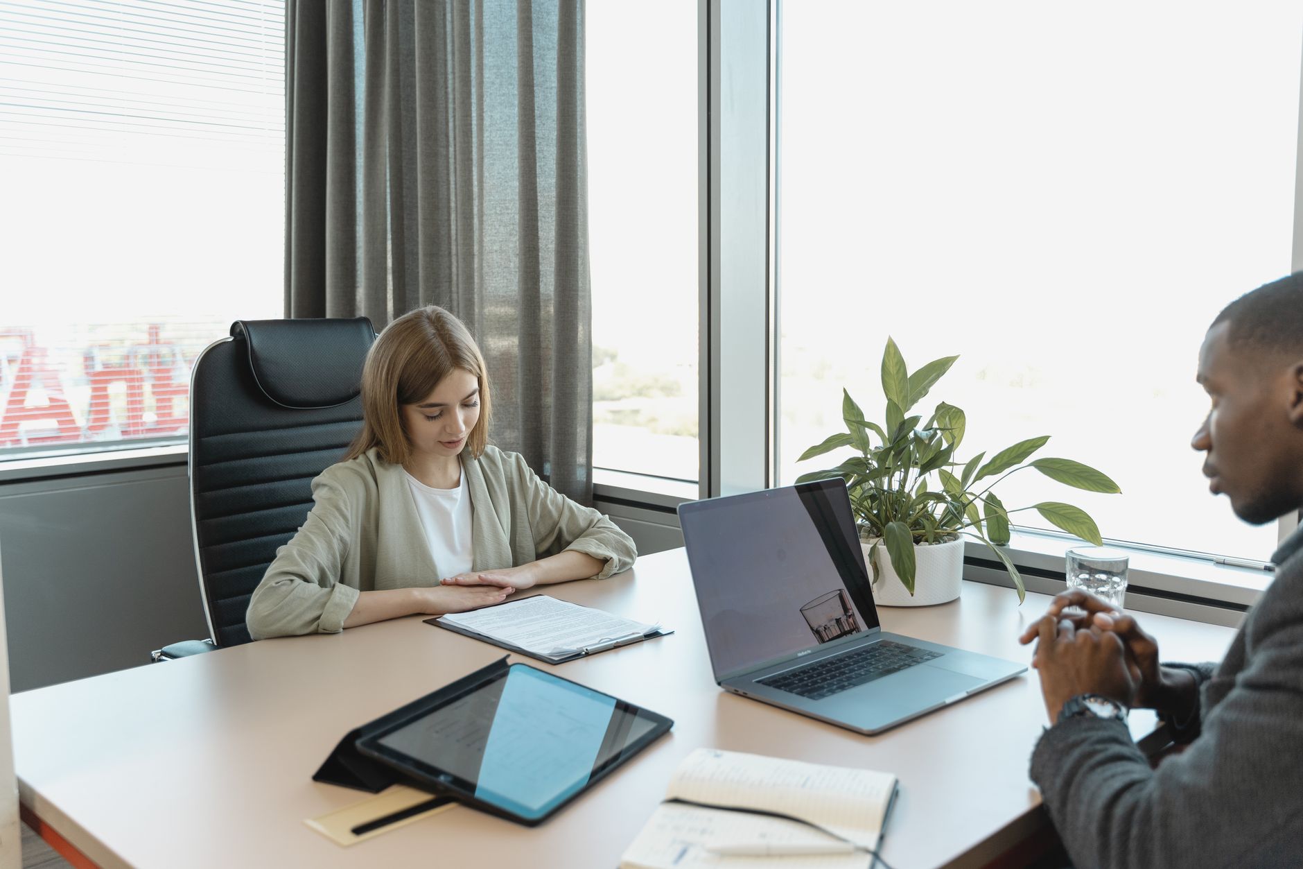HR professionals reviewing health benefits documents during a quarterly plan review meeting