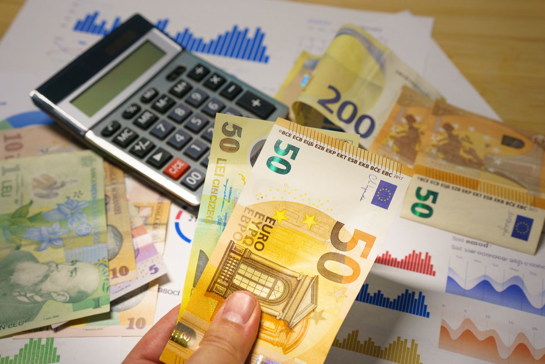 Financial documents and charts representing healthcare reimbursement budget pressures