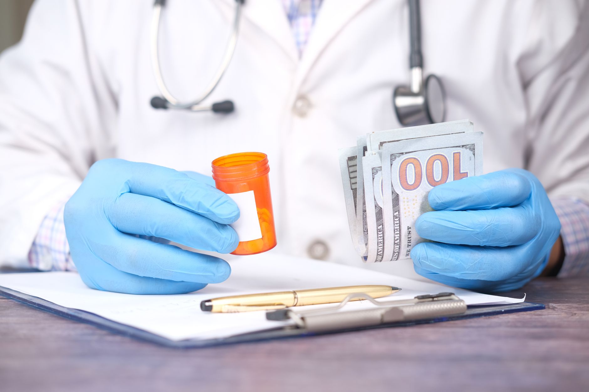 Healthcare financial documents and calculator on a desk in a medical setting