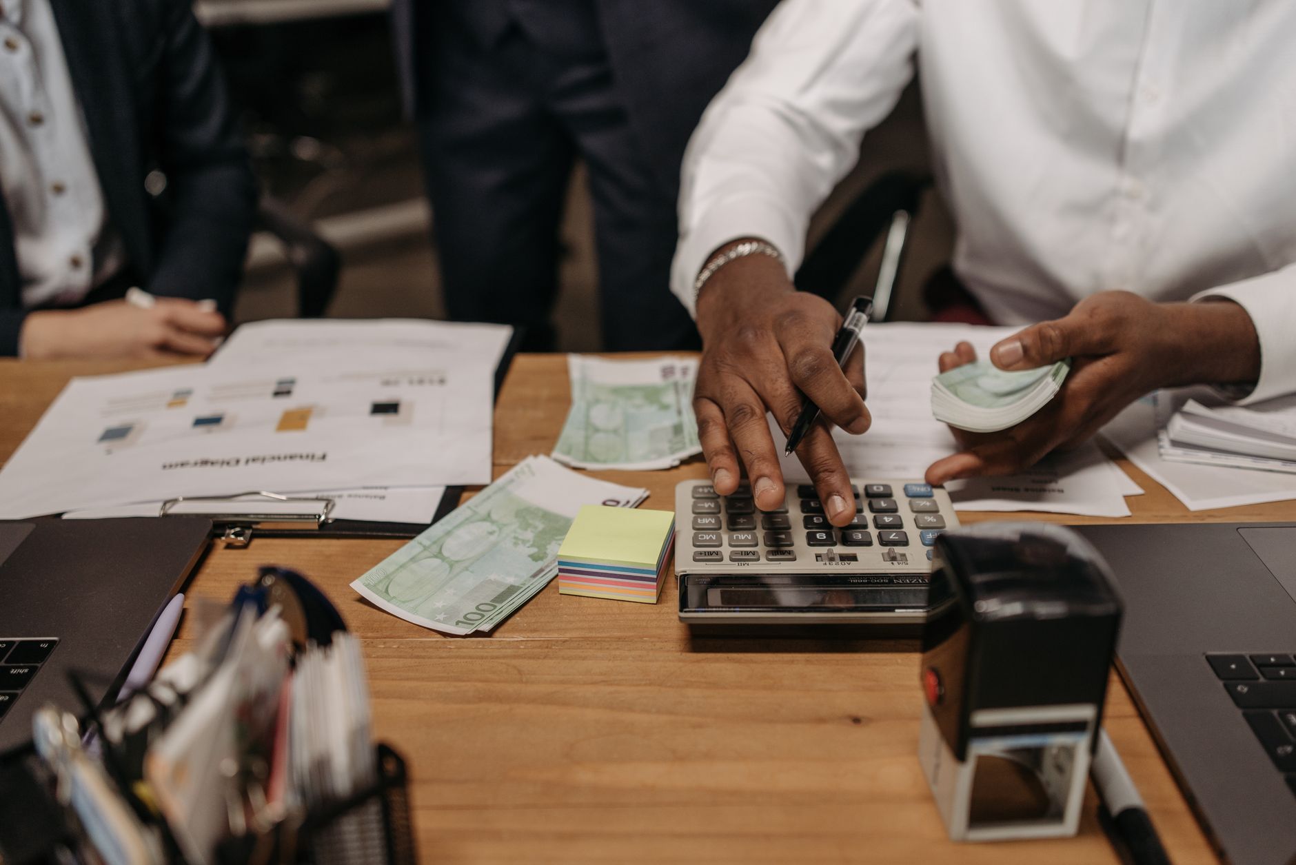 Officials reviewing financial documents at a public budget planning meeting