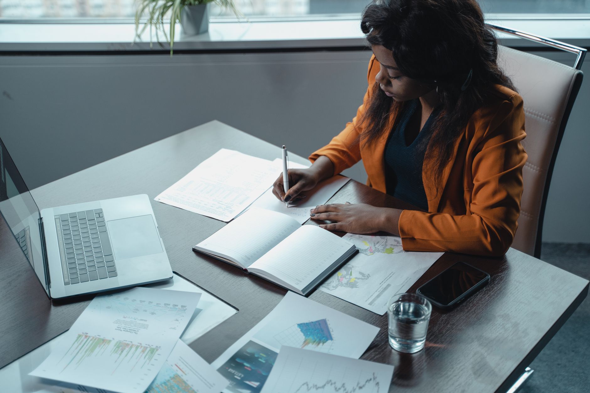 Woman at a desk reviewing documents representing policy and financial pressures in childcare